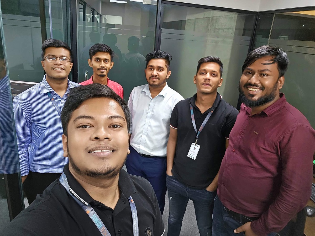 Ashekur Rahman with five colleagues from the Sumashtech web team in the office