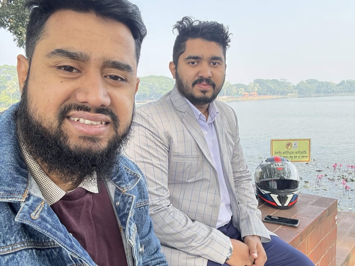 Ashekur Rahman with the Panze Studio CEO sitting by a lake on a clear day